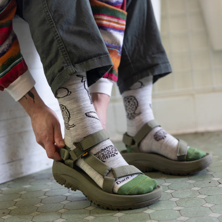 Close up of model putting on sandals wearing the 1678 ash 