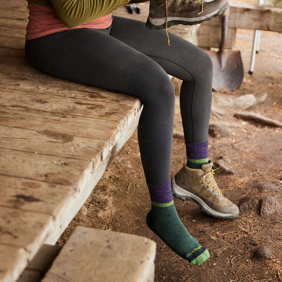 model sitting on leanto putting on shoes wearing 5002 Moss