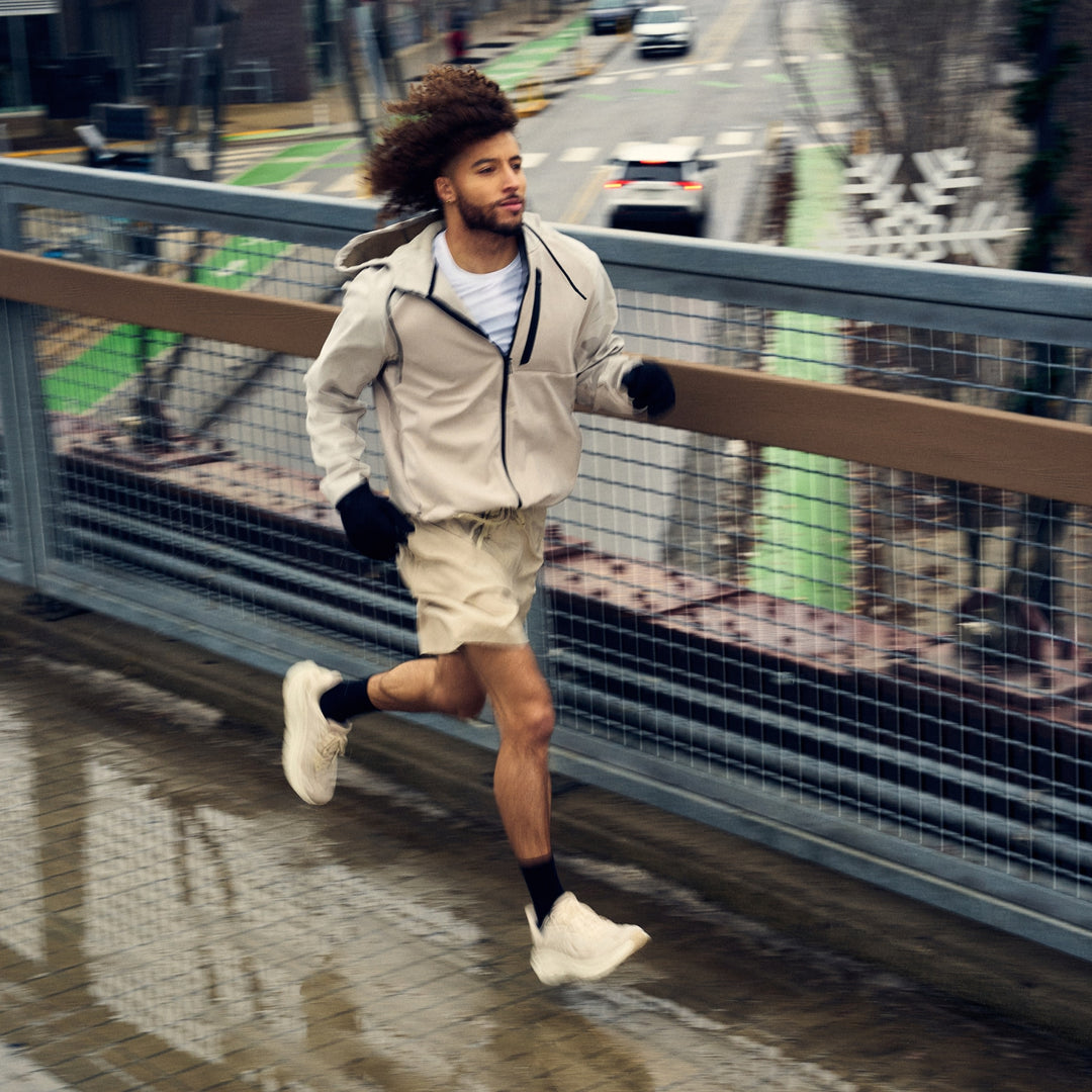 man running on bridge in the rain wearing 1071 run micro crew ultra lightweight with cushion black sock