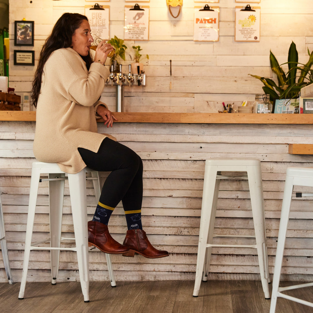 model still on bar stool drinking a beverage wearing the 1678 eclipse