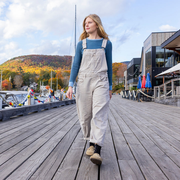 model walking the boardwalk wearing the 6110 pin drop lightweight lifestyle crew in black colorway