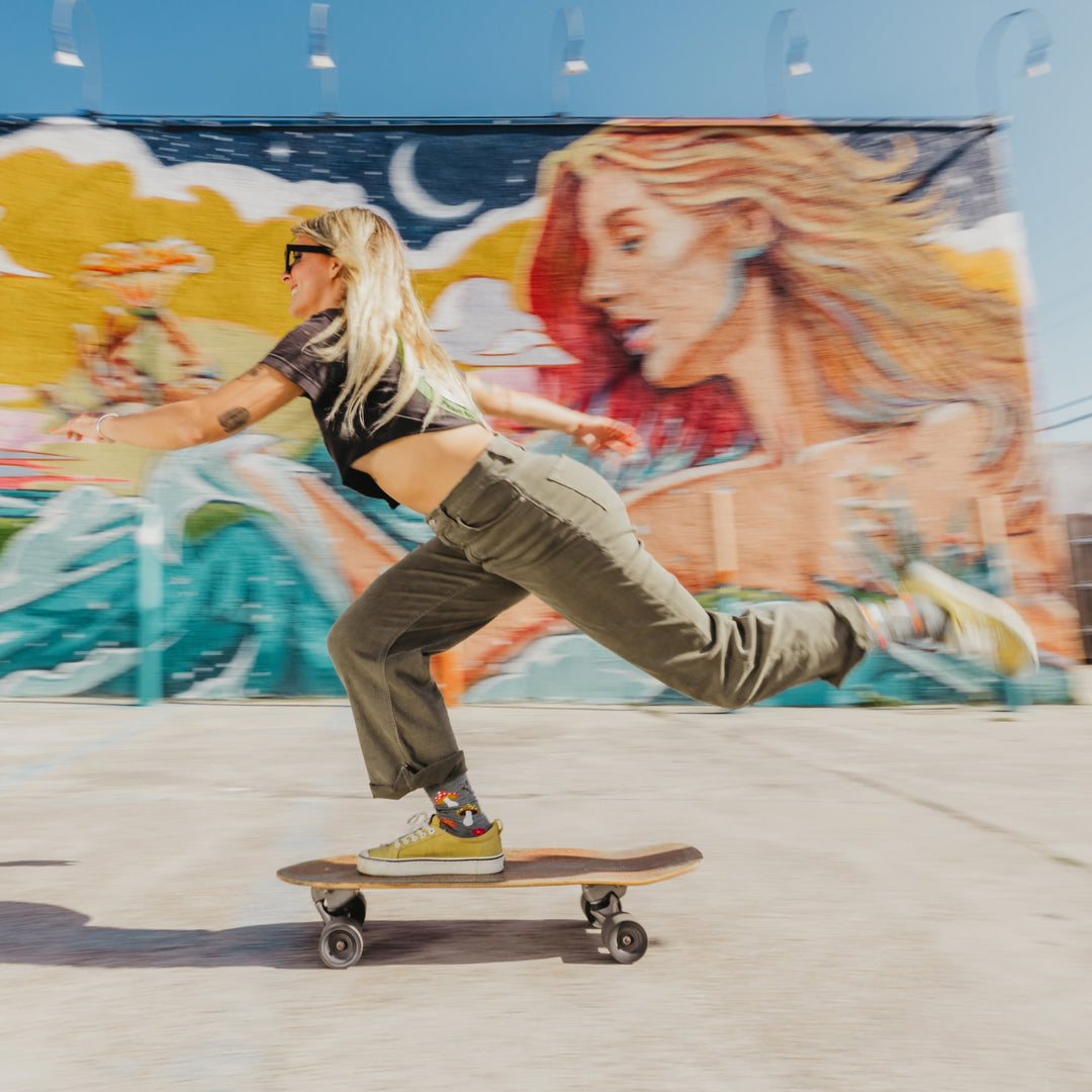 model riding a skateboard wearing the 6133 shroom bloom lightweight lifestyle crew sock in seafoam colorway