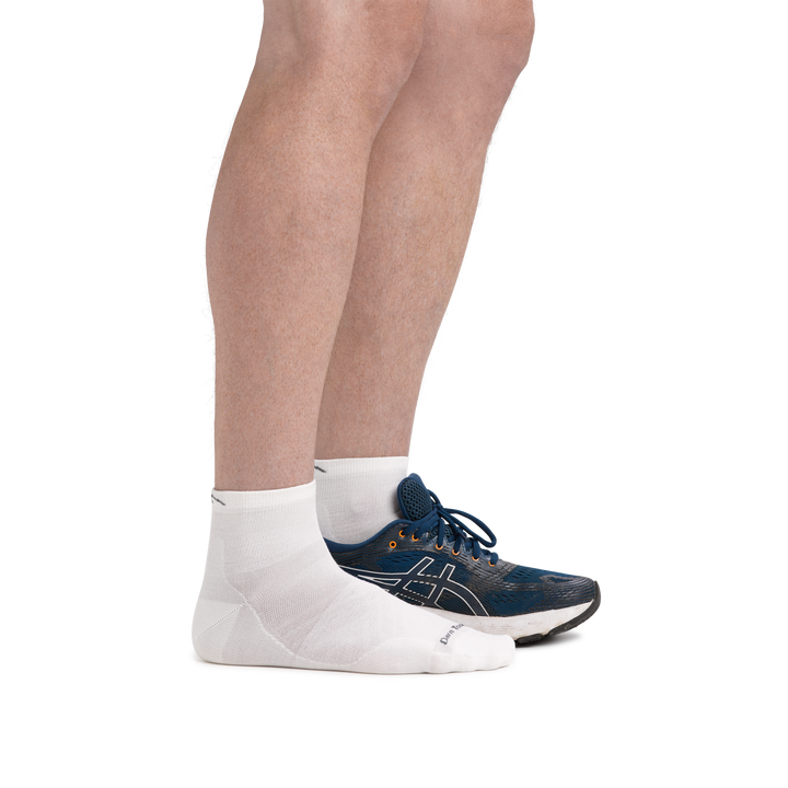 Man wearing Run Quarter Ultra-Lightweight Running Socks in White with back foot also in a running shoe