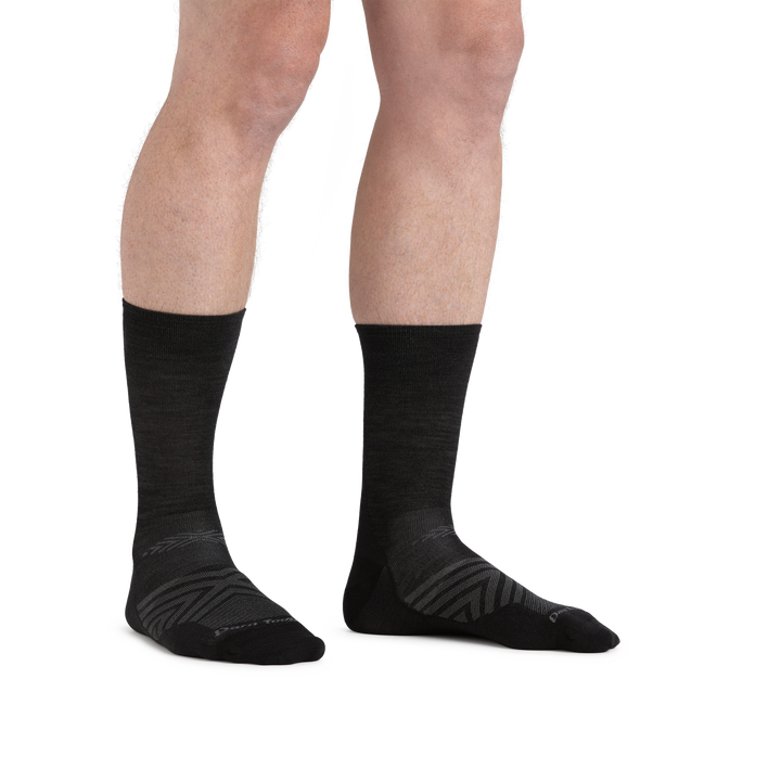 Man standing barefoot wearing Run Micro Crew Ultra-Lightweight Running socks in Black