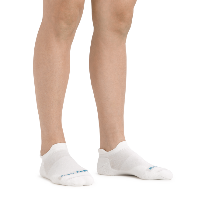 Image of a woman's legs on a white background wearing Women's Run No Show Tab Ultra-Lightweight Running Socks in White