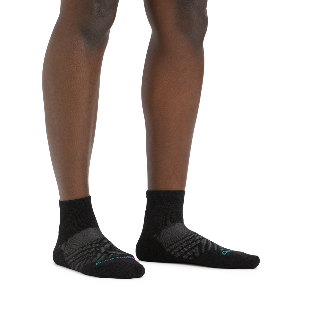 Image of a woman's legs on a white background wearing Women's Run Quarter Ultra-Lightweight Running Socks in Black