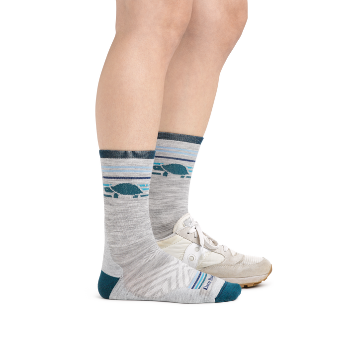 Woman wearing Women's Pacer Micro Crew Ultra-Lightweight Running Socks in Ash with a sneaker on the other foot