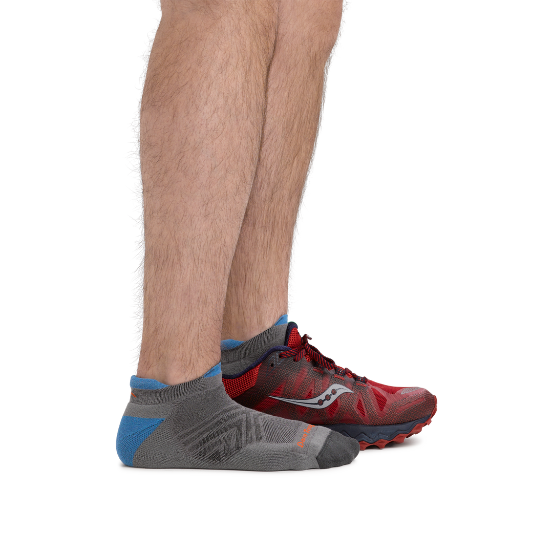 Model wearing men's coolmax run no show running socks in gray, and one sneaker to show height of the sock.