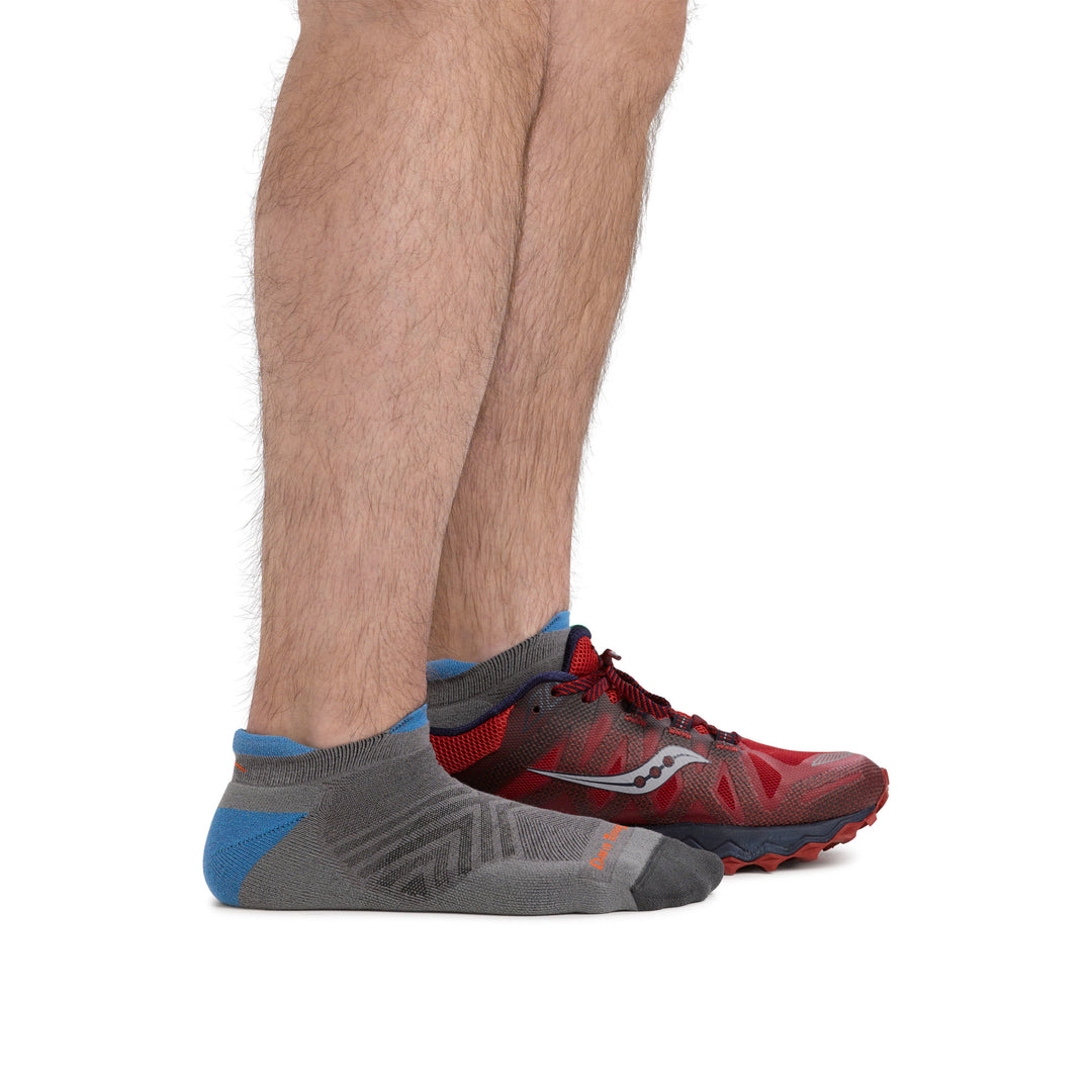 Model wearing men's coolmax run no show running socks in gray, and one sneaker to show height of the sock.