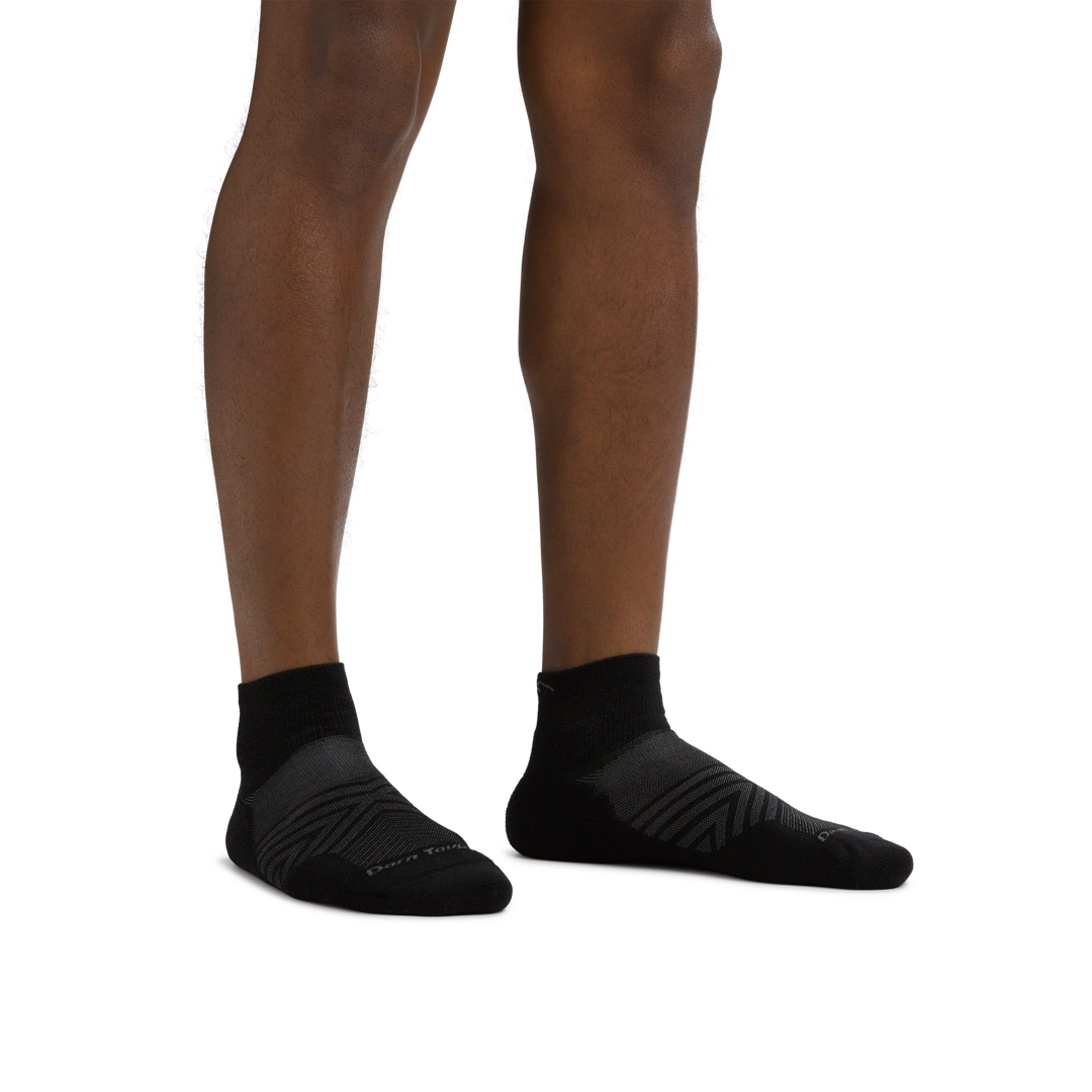 Man standing barefoot wearing Coolmax Run Quarter Ultra-Lightweight Running Sock in Black