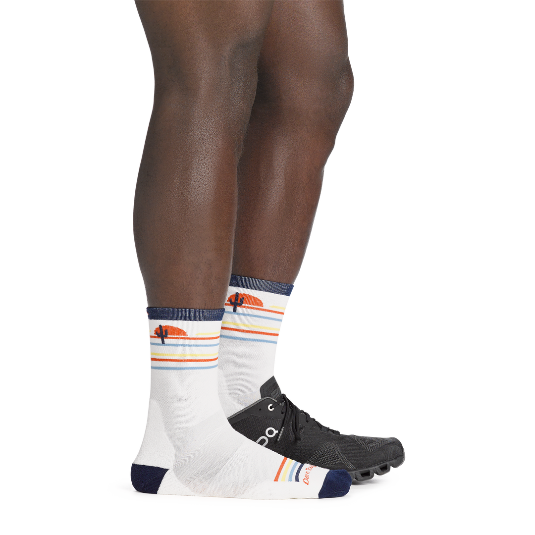 On model image back foot in sneaker, wearing the 1062 front runner micro crew running sock in white colorway.