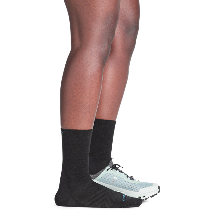on model image with back foot in sneaker wearing the 1068 micro crew running sock in black colorway