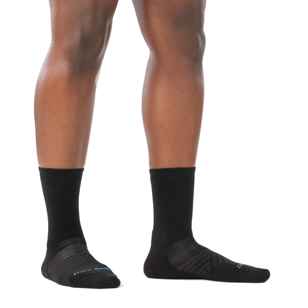 on model image of woman barefoot in staggered stance wearing 1072 black run micro crew ultra lightweight with cushion sock