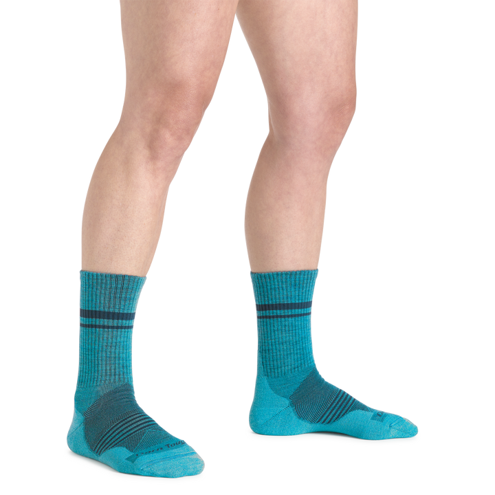 Close up studio shot of model wearing women's element micro crew lightweight running sock in cyan
