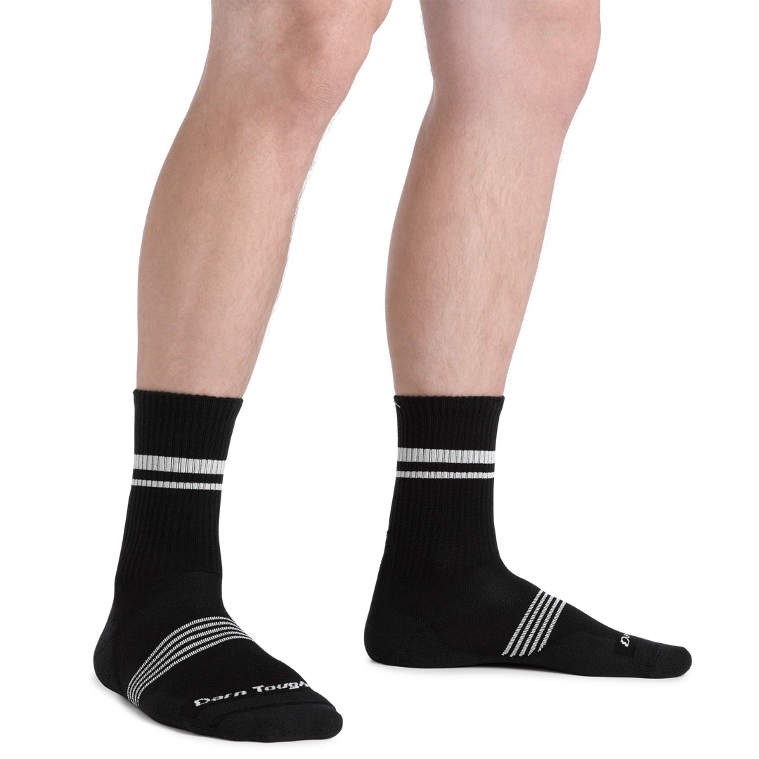 Close up shot of model wearing the men's element micro crew running sock in black with no shoes on
