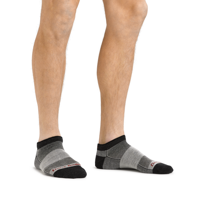 Man standing barefoot wearing 1437 No Show Athletic Sock in charcoal
