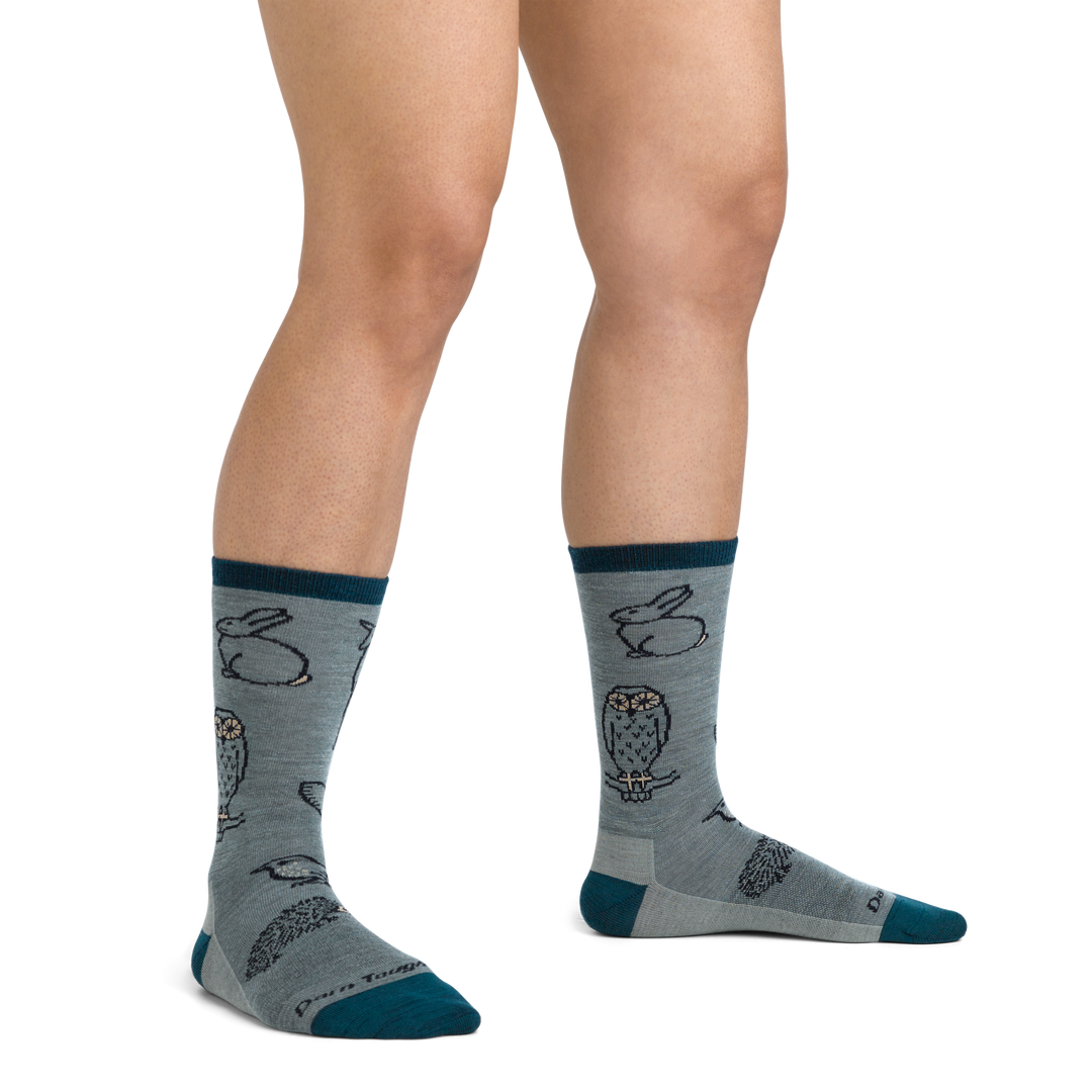 On model image of 1678 Woodland Creatures Lifestyle Sock in Seafoam colorway featuring dark blue accents and gray body