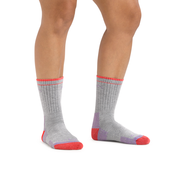 Woman standing barefoot on a white background wearing Coolmax Hiker Micro Crew Midweight Hiking Socks in Light Gray