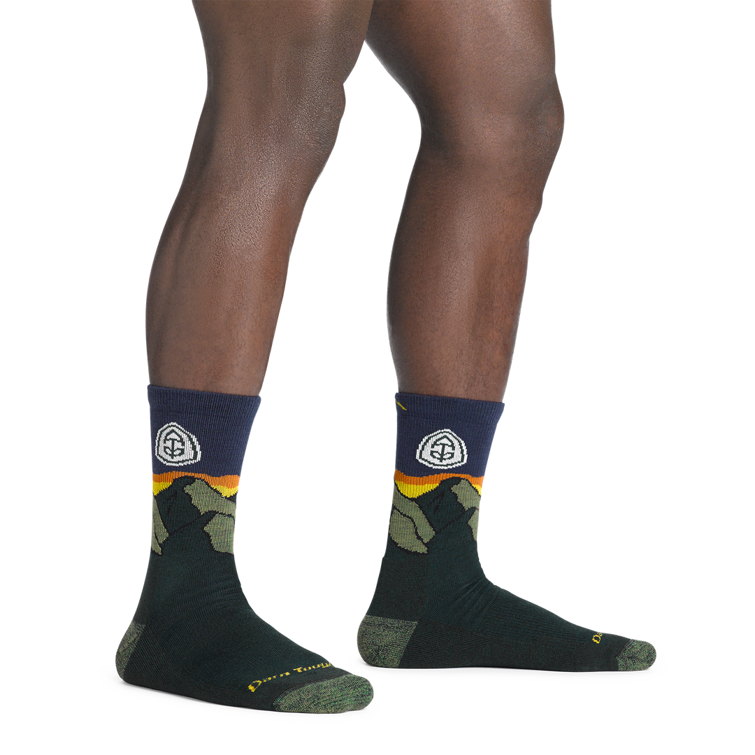 model standing barefoot wearing the 1956 ATC micro crew hiking sock in pine colorway