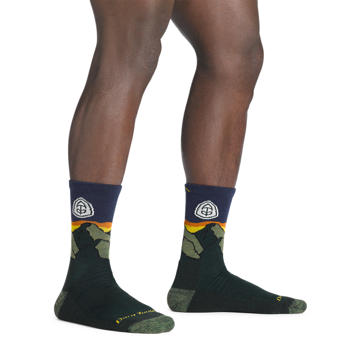 model standing barefoot wearing the 1956 ATC micro crew hiking sock in pine colorway