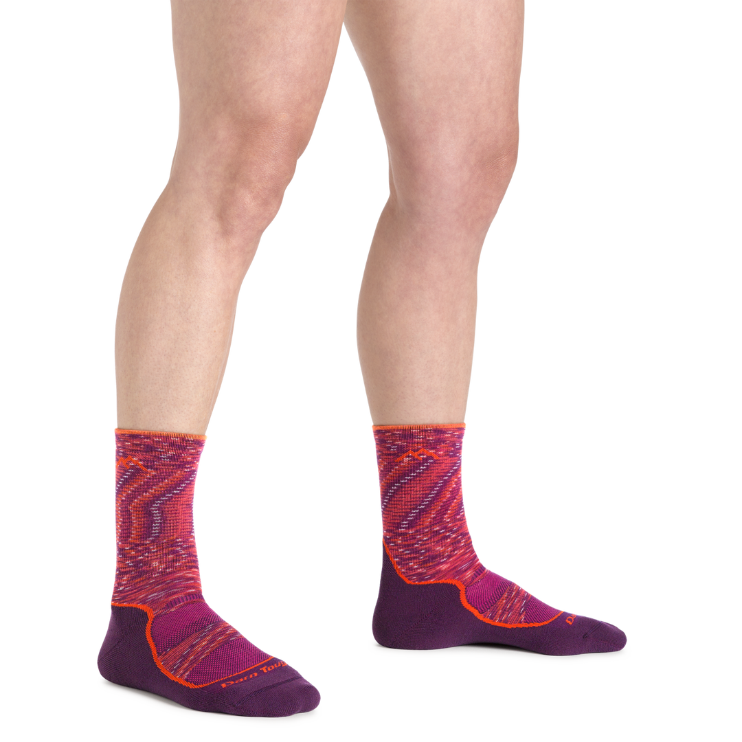 Image of a woman's feet on a white background wearing Women's Light Hiker Micro Crew Lightweight Hiking Socks in Lunar Pink