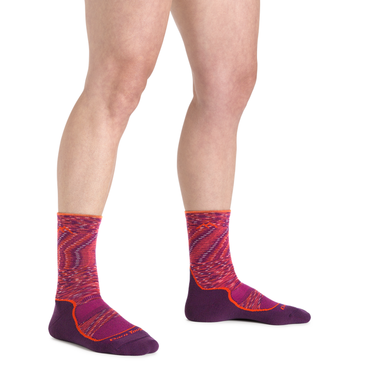 Image of a woman's feet on a white background wearing Women's Light Hiker Micro Crew Lightweight Hiking Socks in Lunar Pink