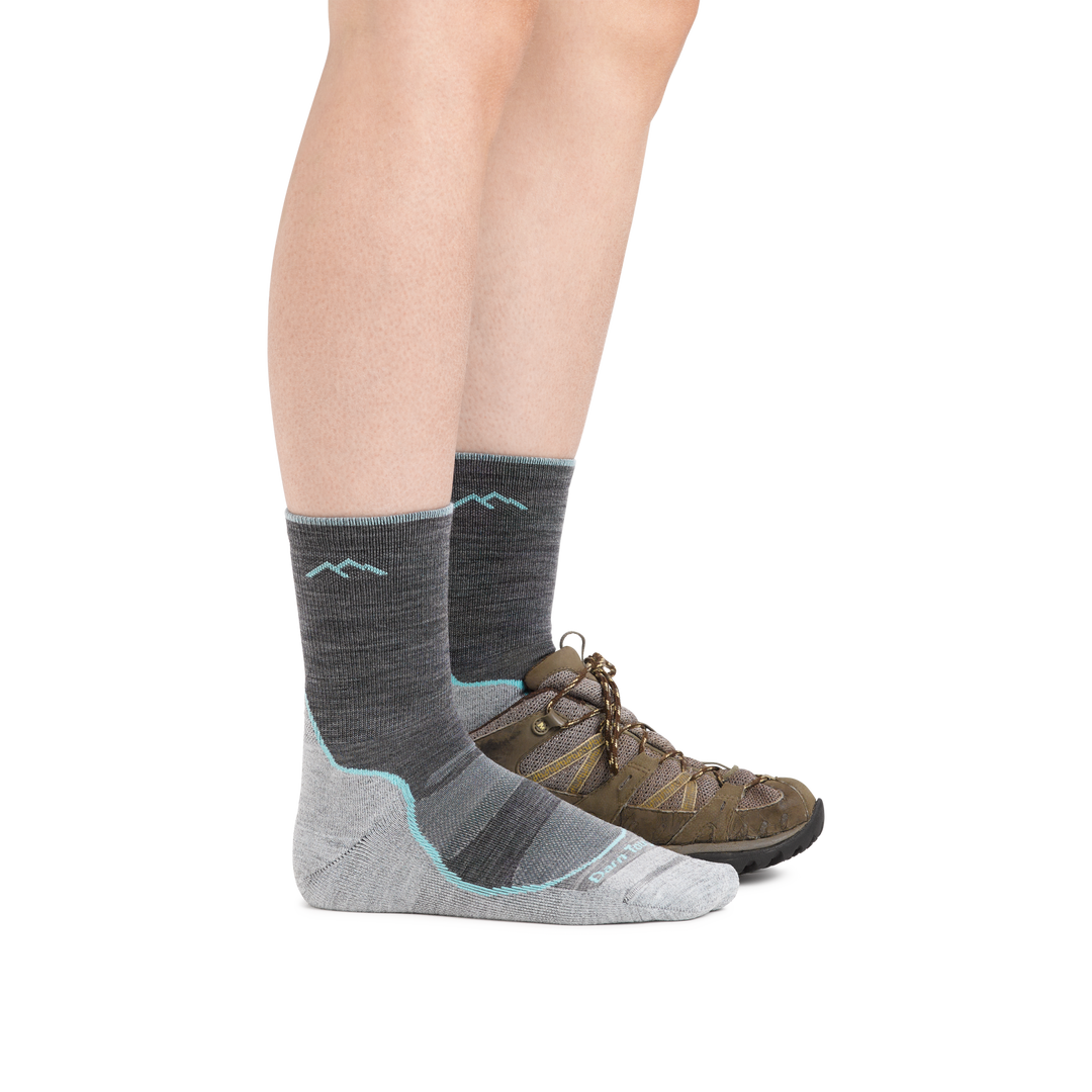 Woman wearing Women's Light Hiker Micro Crew Lightweight Hiking Socks in Slate with one foot also in a hiking shoe