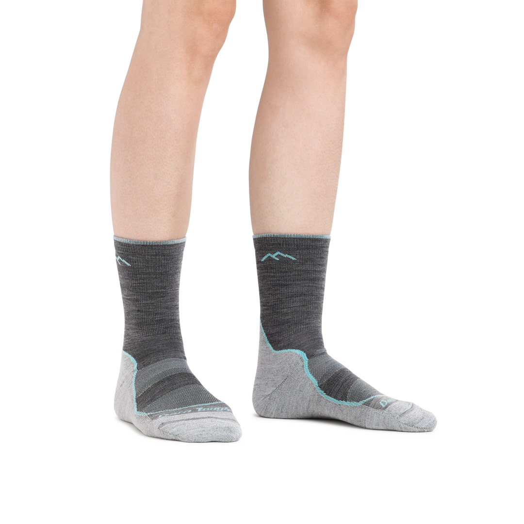 Image of a woman's feet on a white background wearing Women's Light Hiker Micro Crew Lightweight Hiking Socks in Slate