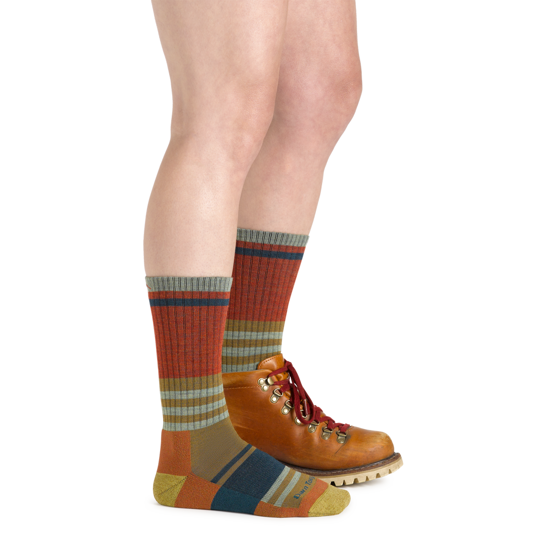 Close up studio shot of model wearing Her Spur socks in Sandstone and brown hiking boots.
