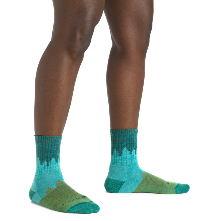 Image of a woman's legs, toes pointed out, wearing Women's Treeline Micro Crew Midweight Hiking Socks in Aqua

