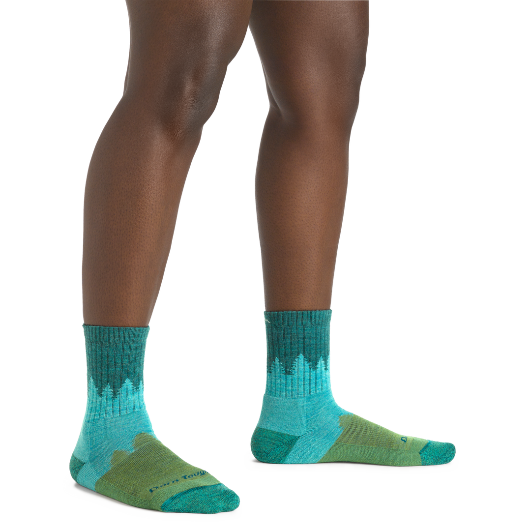 Image of a woman's legs, toes pointed out, wearing Women's Treeline Micro Crew Midweight Hiking Socks in Aqua