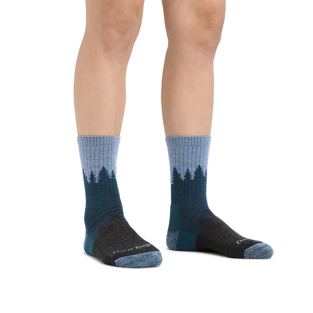 In studio shot of woman standing wearing treeline micro crew hiking socks in blue, showing the height of the sock comes to roughly mid-shin, Lifestyle Image