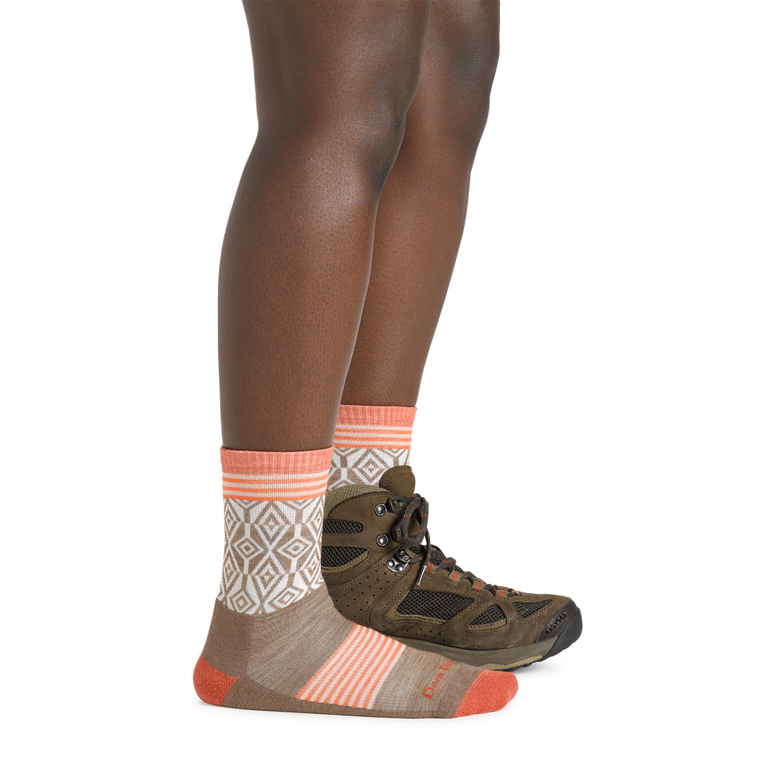 Woman wearing Women's Sobo Micro Crew Lightweight Hiking Socks in bark colorway with one foot also wearing a hiking boot