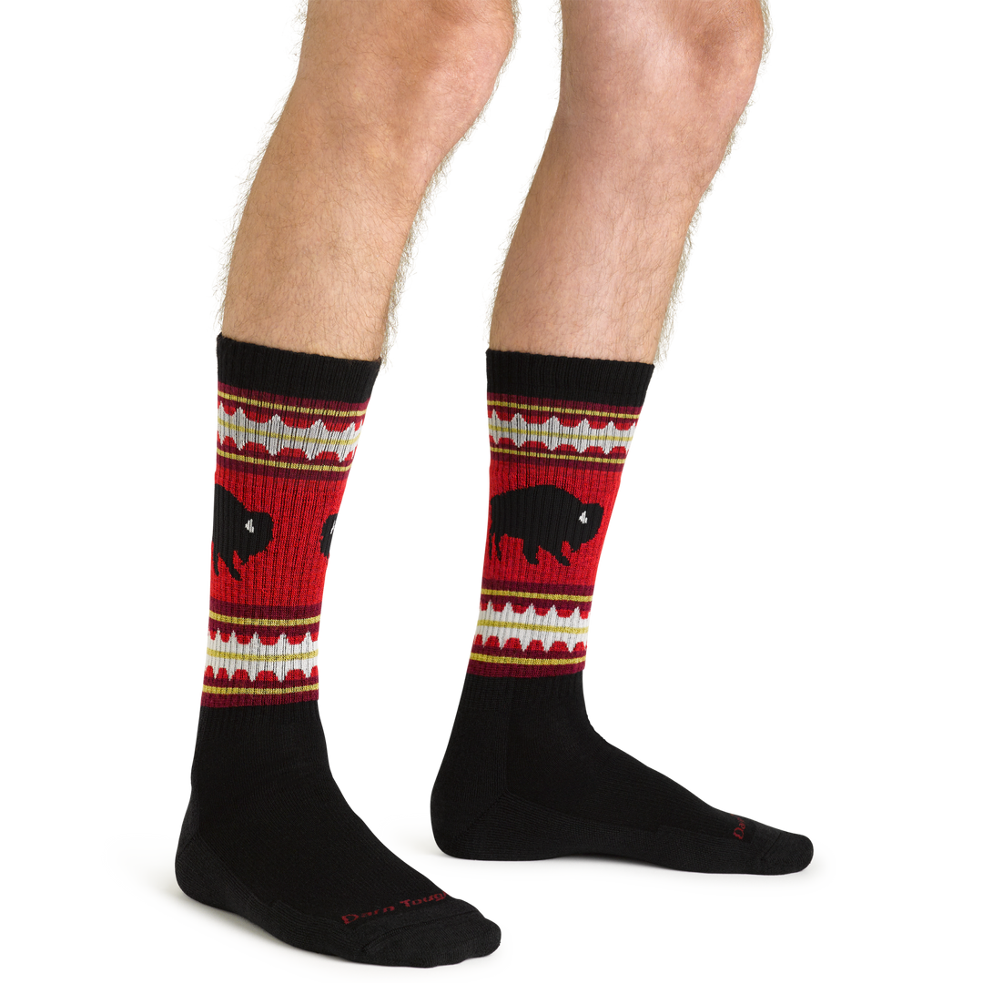 Close up studio shot of model wearing men's vangrizzle boot midweight hiking sock in black