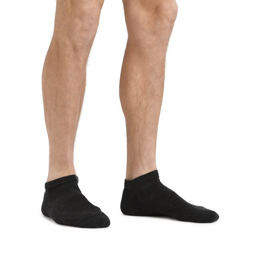 Man standing barefoot wearing Light Hiker No Show Lightweight Hiking Socks in Black