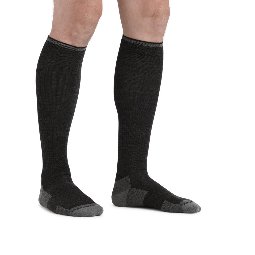 Man standing barefoot wearing Westerner Over the Calf Lightweight work sock in Charcoal