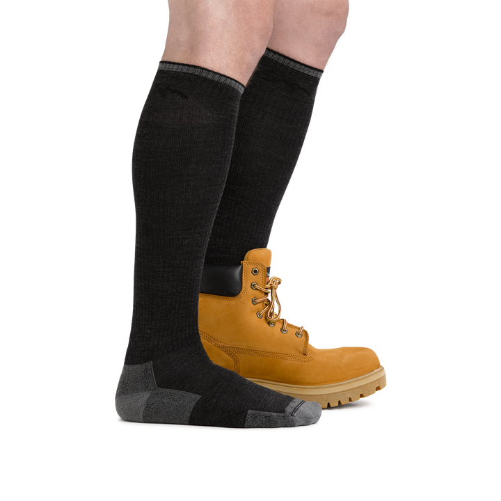 Man wearing Westerner Over the Calf Lightweight work sock in Charcoal, with rear foot wearing a work boot