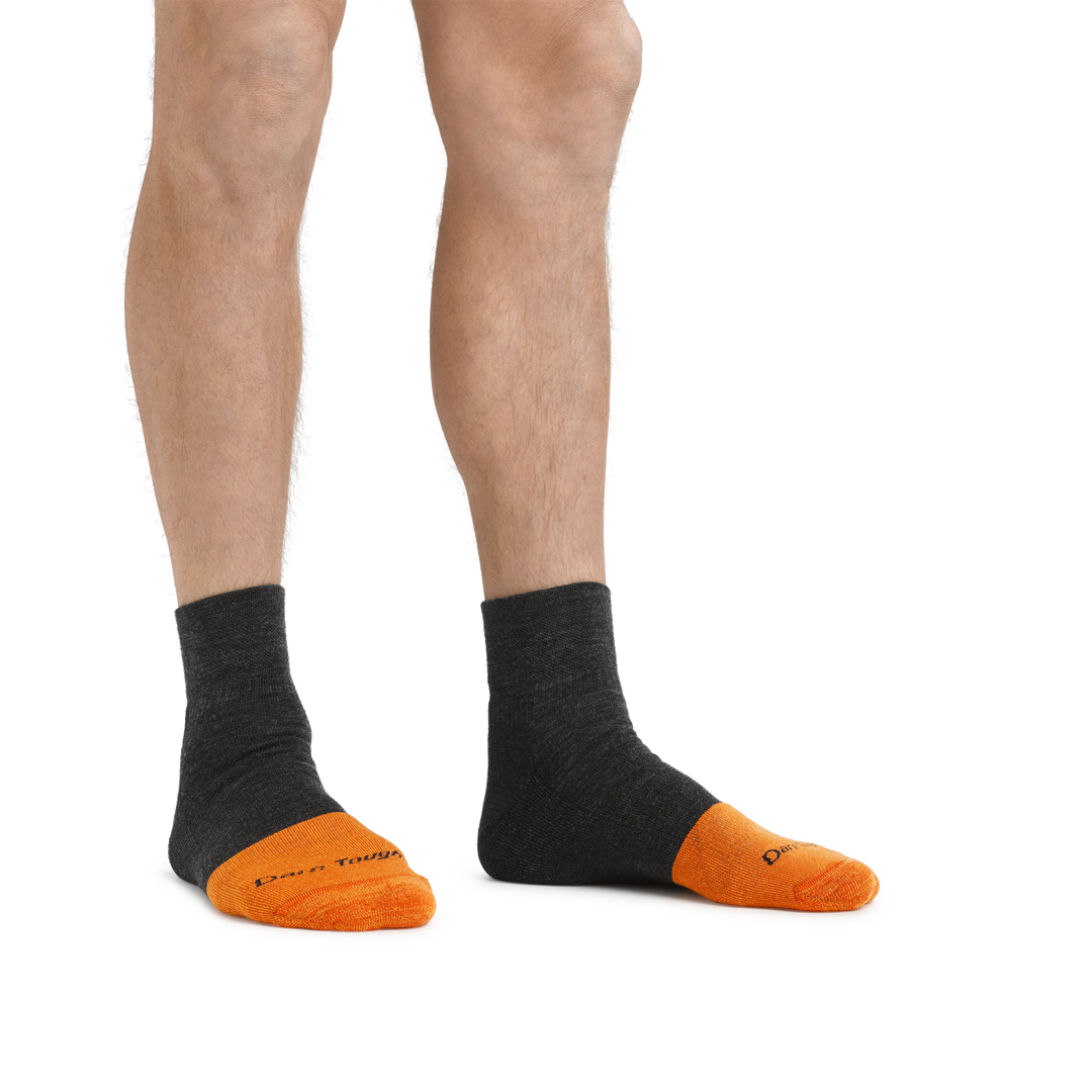 Man standing barefoot wearing Steely Quarter Midweight Work socks in Graphite