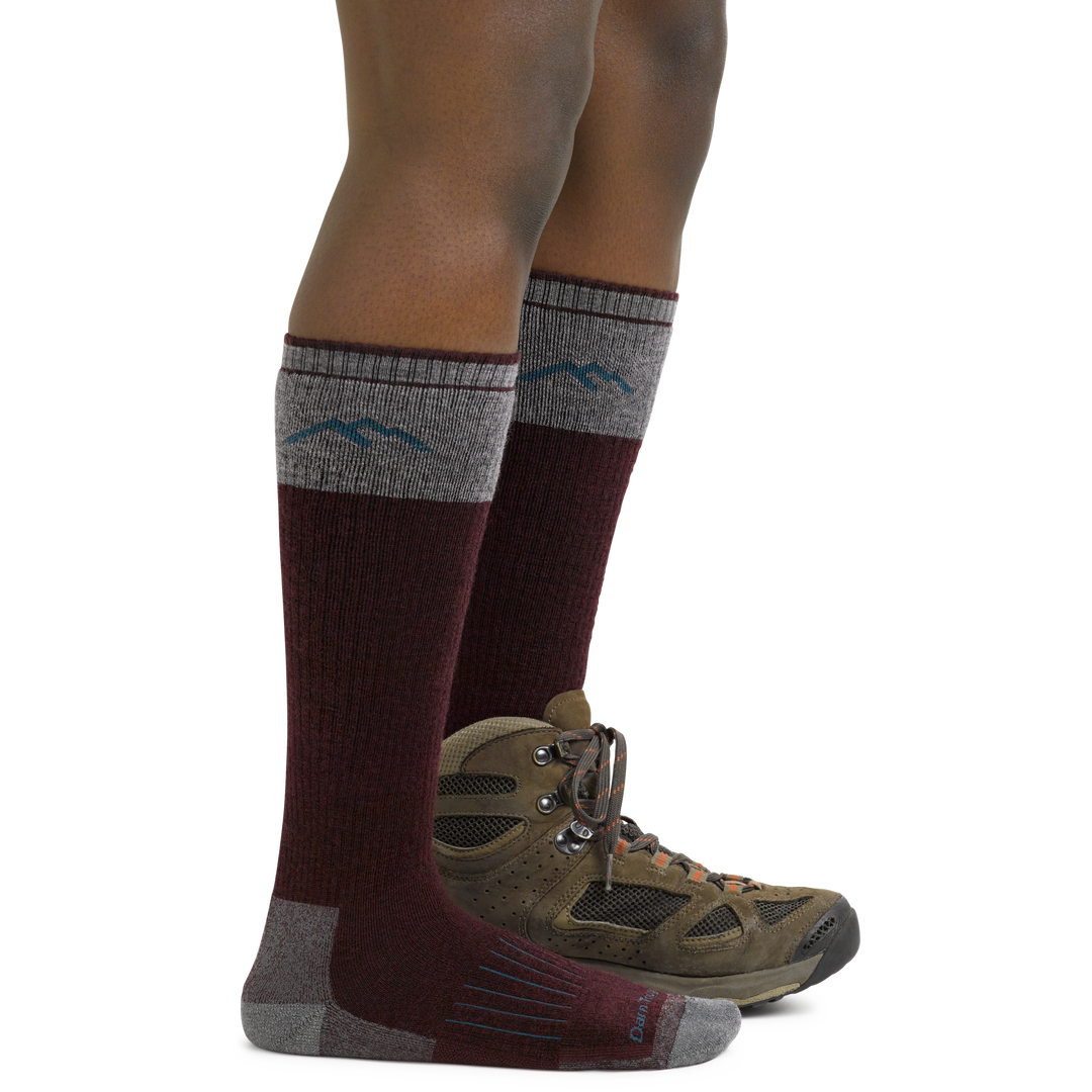 Women's Knee High Hunting Socks in Burgundy on foot with hunting boots