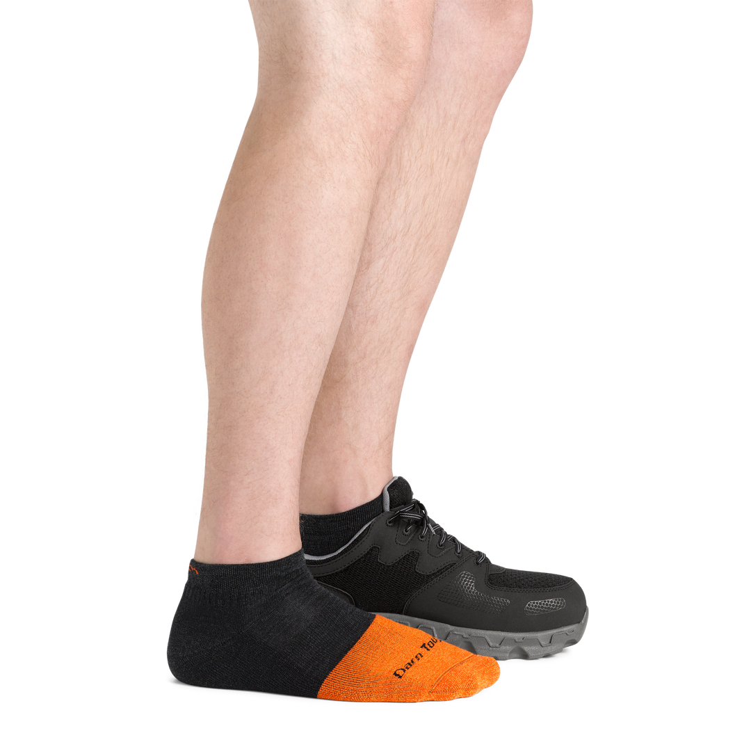 Men's no show Work Socks in graphite on foot with sneaker on left foot