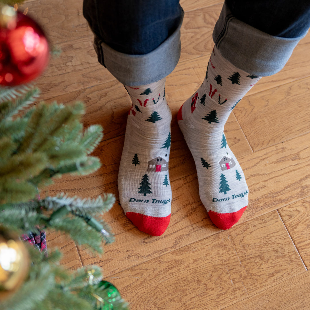 Top view of the bunny slope holiday sock on model stand next to tree