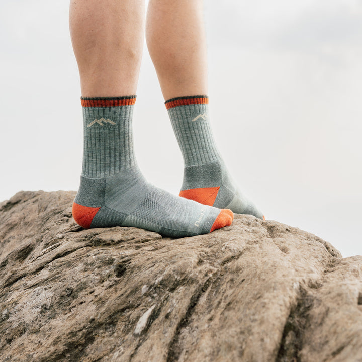 model stand on rock wearing the 1466 Limited edition 1466 day sock in sage colorway