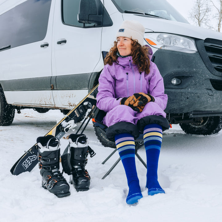 women sitting in chair next to van wearing the 8028 snowburst in marine colorway