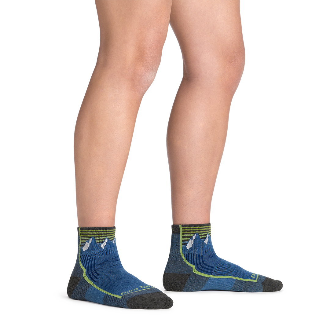 model standing barefoot wearing the 3041 quest quarter hiking sock in mountain blue colorway