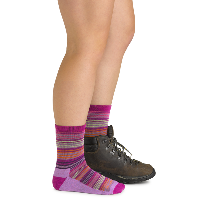 Model wearing the juniors zebra canyon micro crew hiking socks in clover pink with brown boot on her left foot