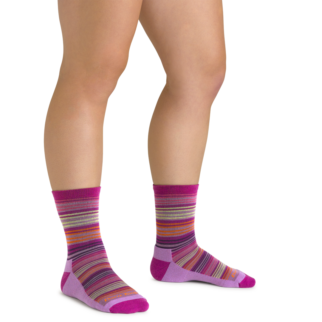 Close up shot of model wearing the kids zebra canyon micro crew hiking socks in clover pink with no shoes on