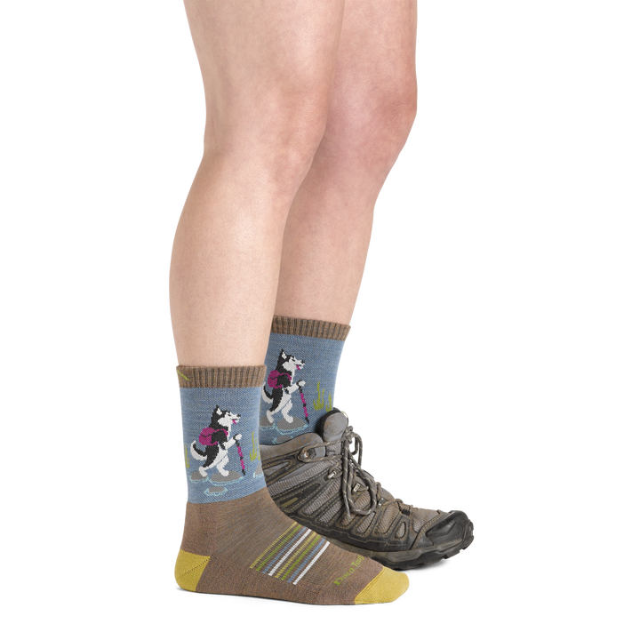 Side shot of model wearing the women's critter club micro crew hiking sock in bark colorway with a brown boot on her left foot