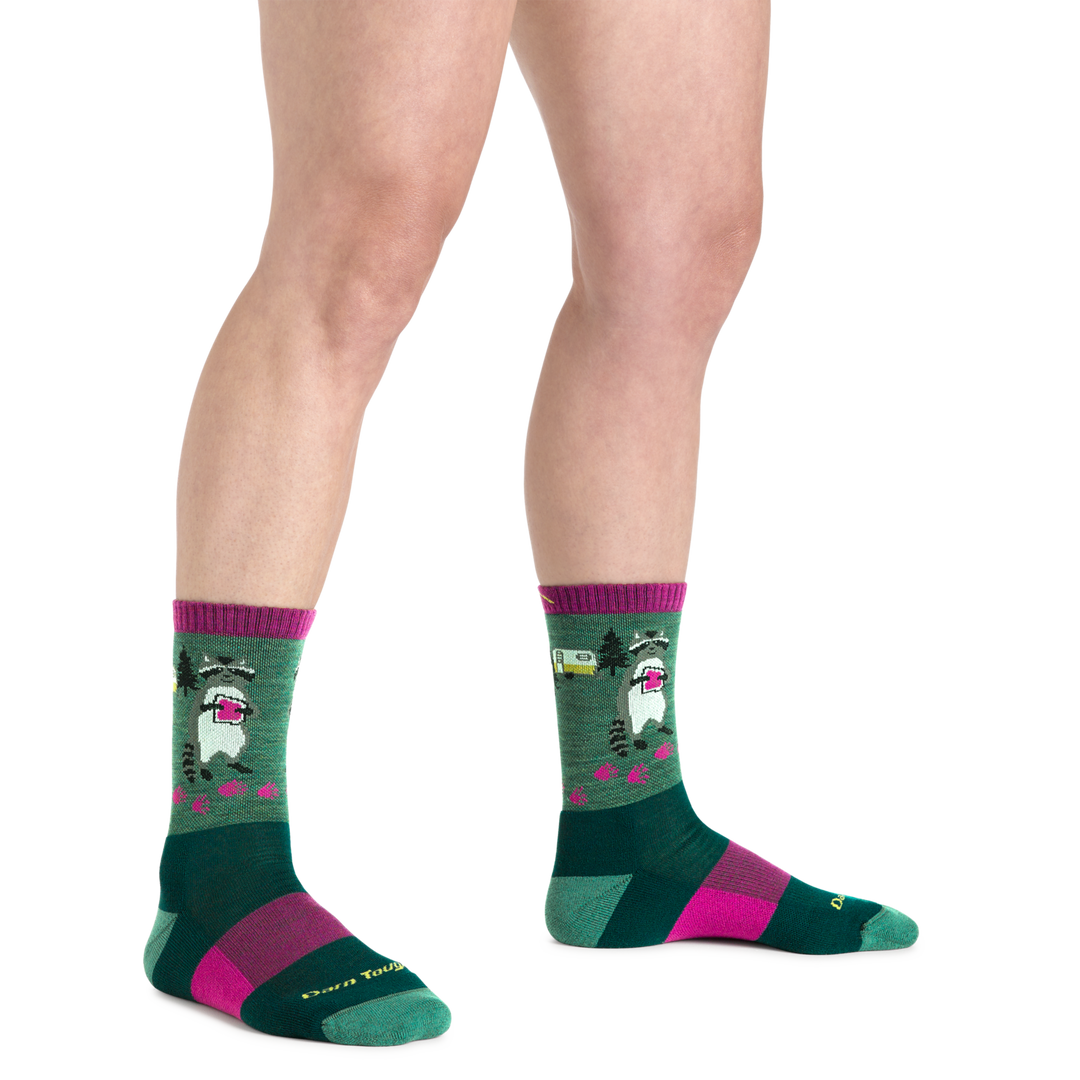 Close up shot of model wearing the women's critter club micro crew hiking sock in Moss green with no shoes on