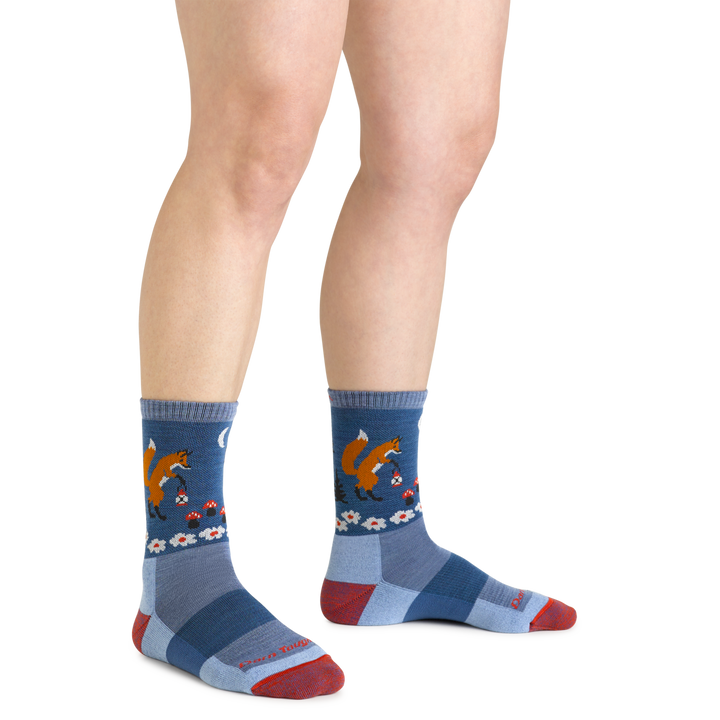 Close up shot of model wearing the women's critter club micro crew hiking sock in vapor blue with no shoes on