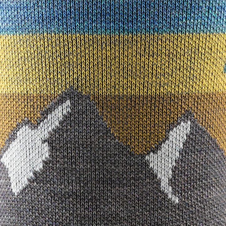 Call out detail image of the of the 5005 Taupe front image of Mountain top with blue yellow and gold background stripes